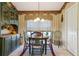 Charming dining room with a round wooden table, decorative wallpaper, and natural light at 13813 Sigler St, Riverview, FL 33579