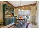 Cozy dining room featuring decorative wallpaper, a charming hutch, and a round wooden table at 13813 Sigler St, Riverview, FL 33579