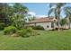 Landscaped yard with vibrant flower beds and lush green grass, enhancing the charm of the home's exterior at 13813 Sigler St, Riverview, FL 33579
