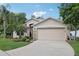 Charming one-story home with a well-manicured lawn and colorful landscaping, with attached two car garage at 13813 Sigler St, Riverview, FL 33579