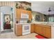 Bright kitchen with wood cabinets, white appliances, and an open layout for easy access at 13813 Sigler St, Riverview, FL 33579