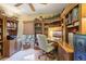 Cozy home office featuring custom built-in shelving and natural light at 13813 Sigler St, Riverview, FL 33579