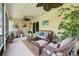 Relaxing screened patio featuring comfortable wicker furniture and tropical plants at 13813 Sigler St, Riverview, FL 33579
