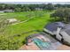 Aerial view of the property featuring a large screened-in pool and proximity to the golf course at 16517 Norwood Dr, Tampa, FL 33624