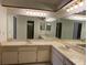 Large vanity mirror spanning across double sinks and counter with cabinet storage at 16517 Norwood Dr, Tampa, FL 33624