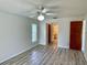 Bright bedroom featuring a ceiling fan, wood floors, and access to the bathroom at 16517 Norwood Dr, Tampa, FL 33624
