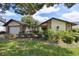 Charming single-Gathering home featuring stone accents, a manicured lawn, and lush landscaping at 16517 Norwood Dr, Tampa, FL 33624