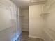 Walk-in closet with multiple metal shelving and wood-look flooring at 16517 Norwood Dr, Tampa, FL 33624