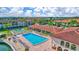 Aerial view of the community pool, clubhouse, tennis court, and surrounding condos at 19029 Us Highway 19 N # 2-23, Clearwater, FL 33764