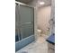 Bathroom featuring a shower-tub combo, toilet, and sink with marble-look flooring at 19029 Us Highway 19 N # 2-23, Clearwater, FL 33764