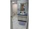 Bathroom featuring a blue vanity, toilet, and white marble-look flooring at 19029 Us Highway 19 N # 2-23, Clearwater, FL 33764