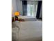 Bright bedroom featuring two twin beds with plush bedding and soft natural light at 19029 Us Highway 19 N # 2-23, Clearwater, FL 33764