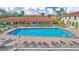 Lovely community swimming pool and lounge area with manicured landscaping surrounding the area at 19029 Us Highway 19 N # 2-23, Clearwater, FL 33764
