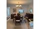 The dining area features wooden table and chairs, decorative lighting, and pass-through to the kitchen at 19029 Us Highway 19 N # 2-23, Clearwater, FL 33764