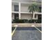 The building's exterior showcases manicured landscaping, covered balconies, and convenient parking at 19029 Us Highway 19 N # 2-23, Clearwater, FL 33764