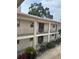 A two-story condo building featuring balconies and well-maintained landscaping at 19029 Us Highway 19 N # 2-23, Clearwater, FL 33764