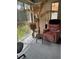 Cozy living area featuring natural light, a comfortable recliner, and stylish decor at 19029 Us Highway 19 N # 2-23, Clearwater, FL 33764