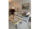 Bright living room featuring a comfortable sofa, stylish coffee table, and nautical themed art at 19029 Us Highway 19 N # 2-23, Clearwater, FL 33764
