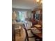 Living room with large window, neutral carpet and furniture, and a dining area at 19029 Us Highway 19 N # 2-23, Clearwater, FL 33764