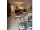 Open layout combining living and dining areas with comfortable furniture and natural light at 19029 Us Highway 19 N # 2-23, Clearwater, FL 33764