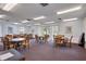 This spacious recreation room is furnished with multiple tables and chairs, creating an ideal space for community events at 19029 Us Highway 19 N # 2-23, Clearwater, FL 33764