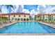 Inviting community pool with ample lounging space and views of the surrounding property at 19029 Us Highway 19 N # 2-23, Clearwater, FL 33764