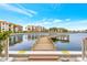 Beautiful waterfront view of the pier, community buildings, and waterway with clear blue skies overhead at 19029 Us Highway 19 N # 2-23, Clearwater, FL 33764