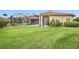 Expansive backyard with a screened lanai, lush lawn, and mature landscaping at 19107 Avenue Bayonnes, Lutz, FL 33558