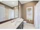 Well-lit bathroom with a large mirror, shower with white curtains, and white-tiled floors at 19107 Avenue Bayonnes, Lutz, FL 33558