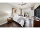 Inviting bedroom with hardwood floors, white bedding, patio access, and natural light at 19107 Avenue Bayonnes, Lutz, FL 33558