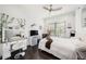 Well-lit bedroom with a vanity, large window, dark wood floors, and a white color scheme at 19107 Avenue Bayonnes, Lutz, FL 33558