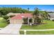 Beautiful home showcasing a well-manicured lawn, lovely landscaping, and a three-car garage at 19107 Avenue Bayonnes, Lutz, FL 33558