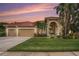 Charming exterior of home with tile roof, arched entry, and lush landscaping at sunset at 19107 Avenue Bayonnes, Lutz, FL 33558
