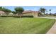 Well-maintained home boasts a manicured lawn, mature trees, and a two-car garage at 19107 Avenue Bayonnes, Lutz, FL 33558