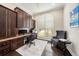 Home office featuring built-in cabinets and a large window with plantation shutters at 19107 Avenue Bayonnes, Lutz, FL 33558