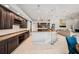 Spacious kitchen with dark wood cabinets, granite countertops, bar seating, and modern appliances at 19107 Avenue Bayonnes, Lutz, FL 33558