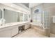 Bright main bathroom featuring a soaking tub, dual vanity, and plenty of cabinet space at 19107 Avenue Bayonnes, Lutz, FL 33558