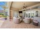 Outdoor lounge area with comfortable seating, ceiling fan, and views of the pool and lush landscaping at 19107 Avenue Bayonnes, Lutz, FL 33558