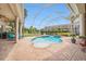 Inviting screened-in pool and spa area with a beautiful view of manicured landscaping at 19107 Avenue Bayonnes, Lutz, FL 33558