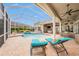 Relaxing screened-in pool area with lounge chairs and a covered patio perfect for entertaining at 19107 Avenue Bayonnes, Lutz, FL 33558