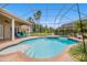 A gorgeous, screened-in pool and spa provide a refreshing backyard oasis with lush tropical landscaping at 19107 Avenue Bayonnes, Lutz, FL 33558