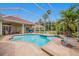 The refreshing screened-in pool and spa area offers a relaxing outdoor space, surrounded by palms at 19107 Avenue Bayonnes, Lutz, FL 33558