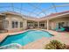 Relax in the screened pool and spa area, complete with poolside seating and a brick-paved patio at 19107 Avenue Bayonnes, Lutz, FL 33558