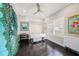 Bright room with dark wood floors, white trim, with a ceiling fan and a large work table at 19107 Avenue Bayonnes, Lutz, FL 33558