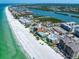 Attractive aerial shot of beachfront condos with sparkling blue ocean waters and sandy shoreline at 19530 Gulf Blvd # 4A, Indian Shores, FL 33785