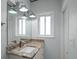 Bathroom featuring a granite countertop, framed mirror, and modern light fixtures at 19530 Gulf Blvd # 4A, Indian Shores, FL 33785