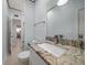 Bathroom featuring a granite countertop, framed mirror, and modern light fixtures at 19530 Gulf Blvd # 4A, Indian Shores, FL 33785