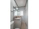 Bathroom featuring a granite countertop, framed mirror, and modern light fixtures at 19530 Gulf Blvd # 4A, Indian Shores, FL 33785