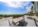 Beachside deck with table and chairs, and lounge chairs, for relaxing by the ocean at 19530 Gulf Blvd # 4A, Indian Shores, FL 33785