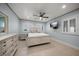 Well-lit bedroom with ceiling fan, shutters, and dresser at 19530 Gulf Blvd # 4A, Indian Shores, FL 33785